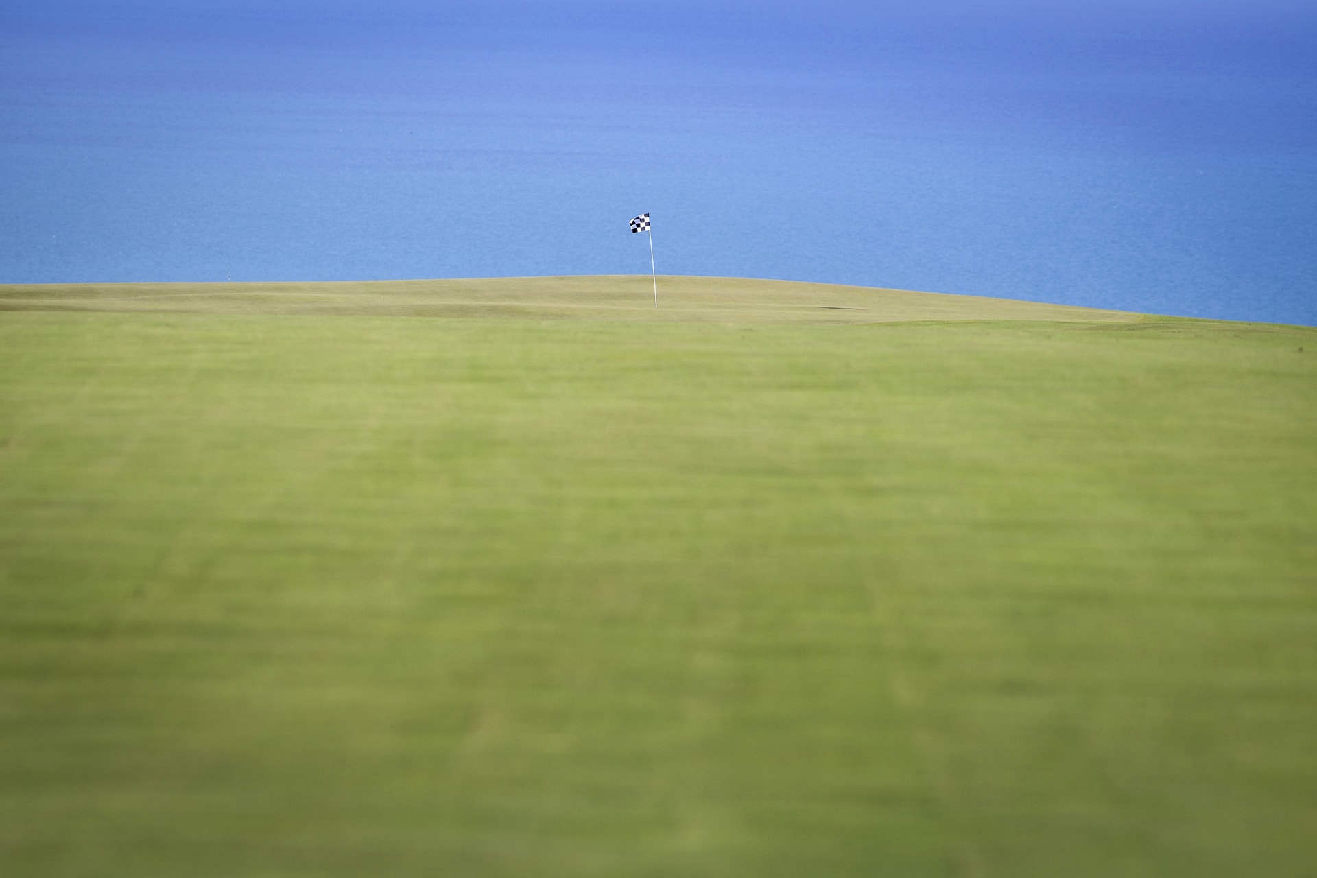 Golfer tee shot silhouette at sunset